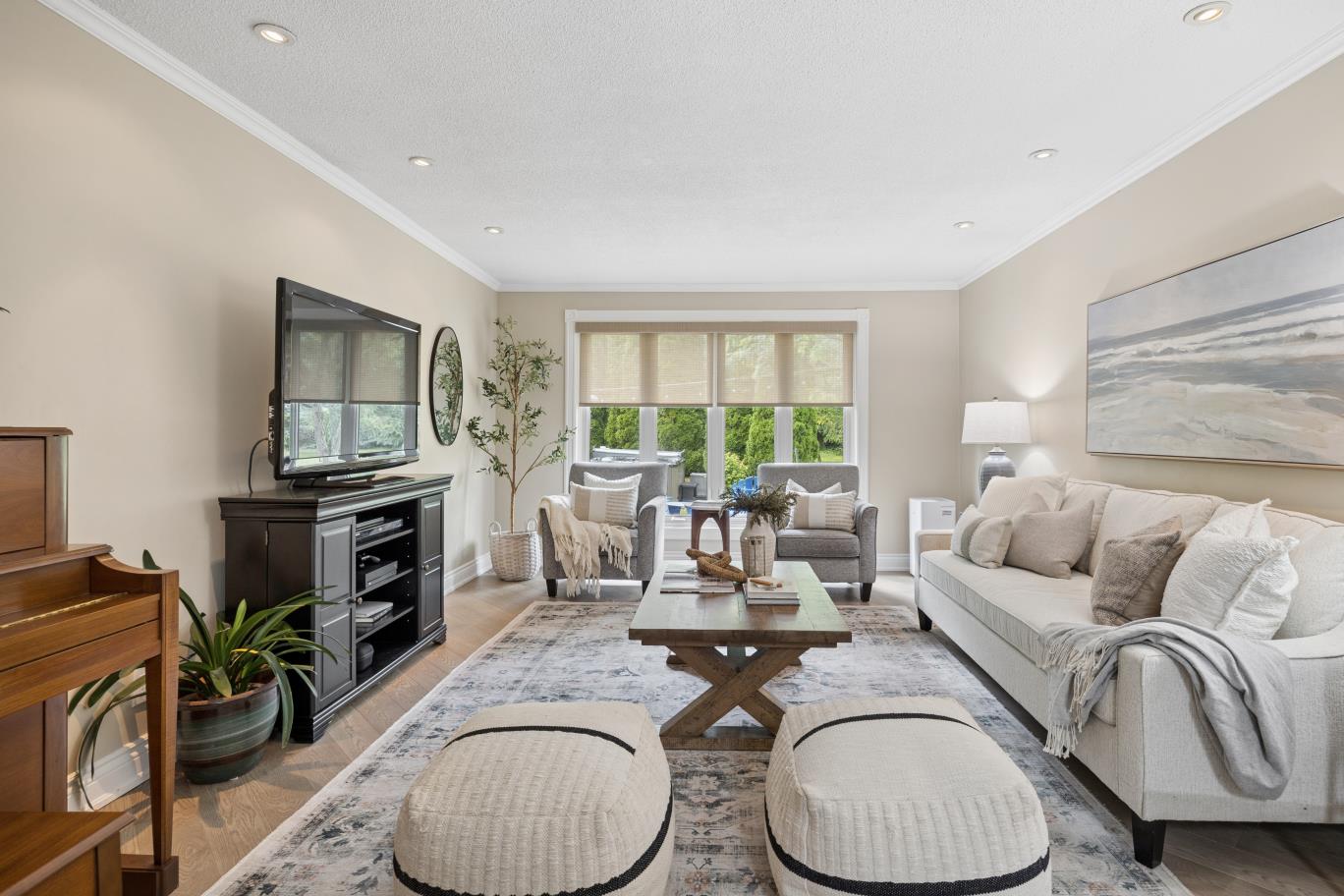 Living room facing updated front windows and mature trees at 30 Potters Lane