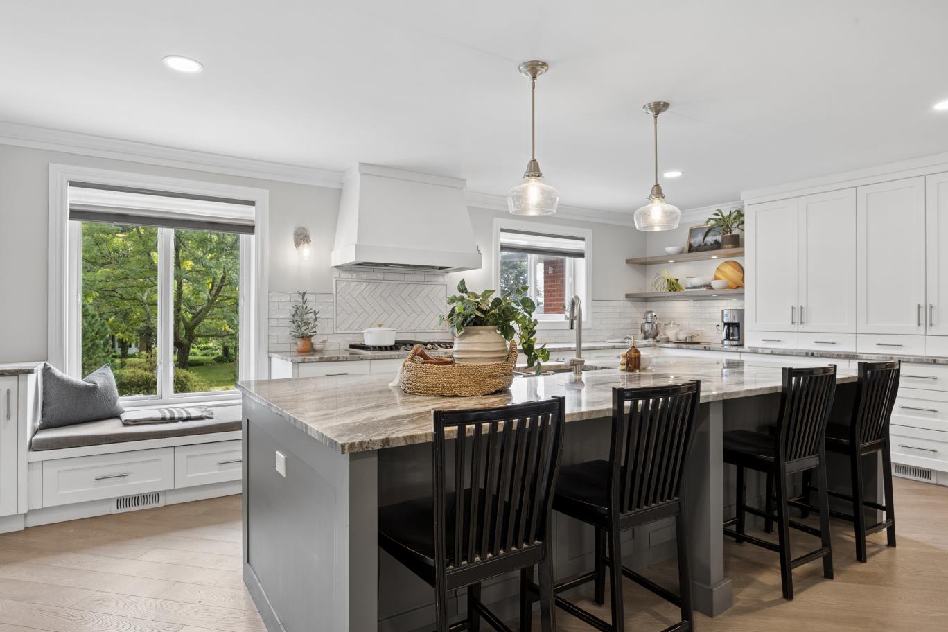 Large kitchen island with bar seating and white cabinetry at 30 Potters Lane