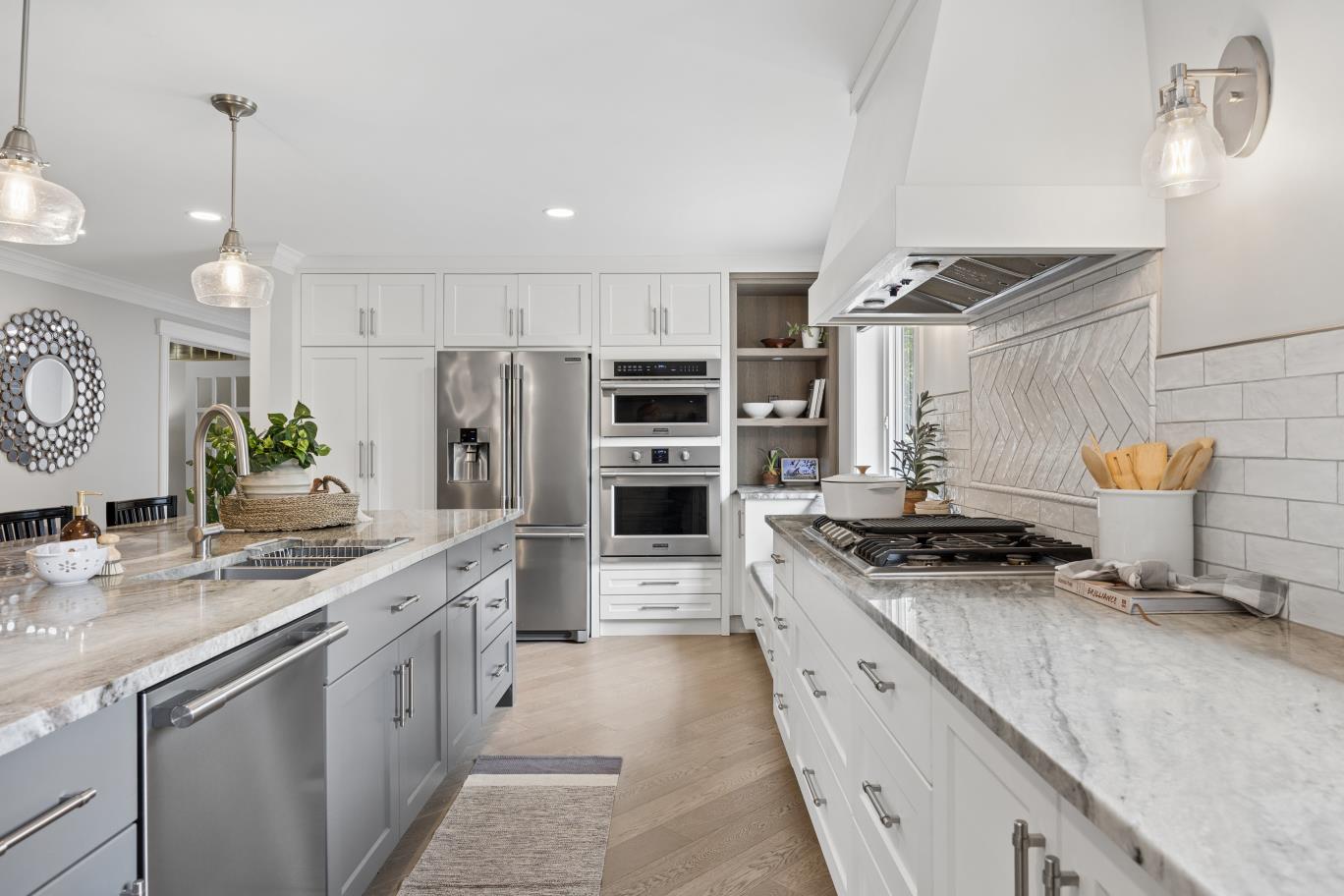 Galley view of quartzite counters and stainless steel appliances at 30 Potters Lane