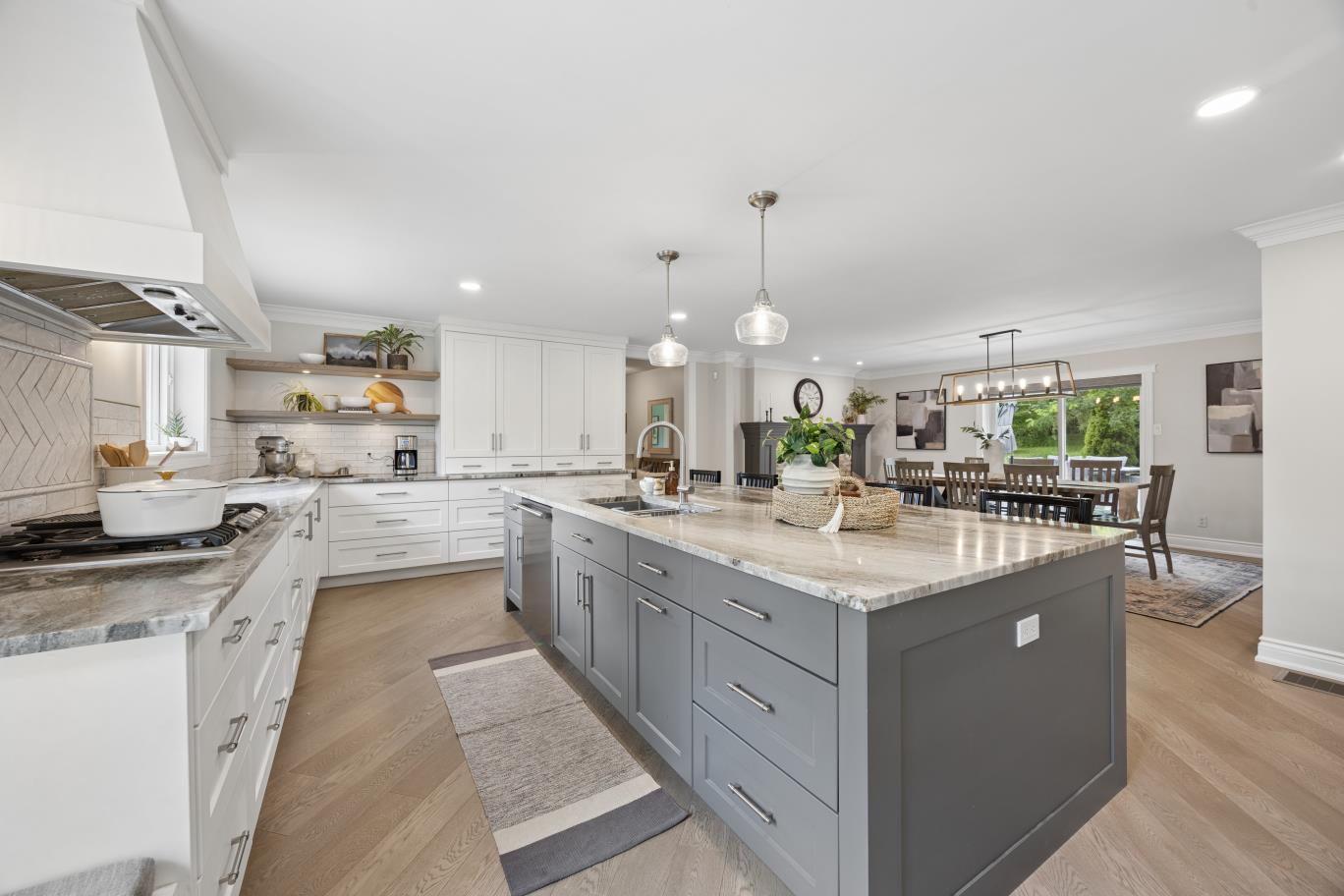 Kitchen flowing into dining room with patio doors at 30 Potters Lane, Clarington